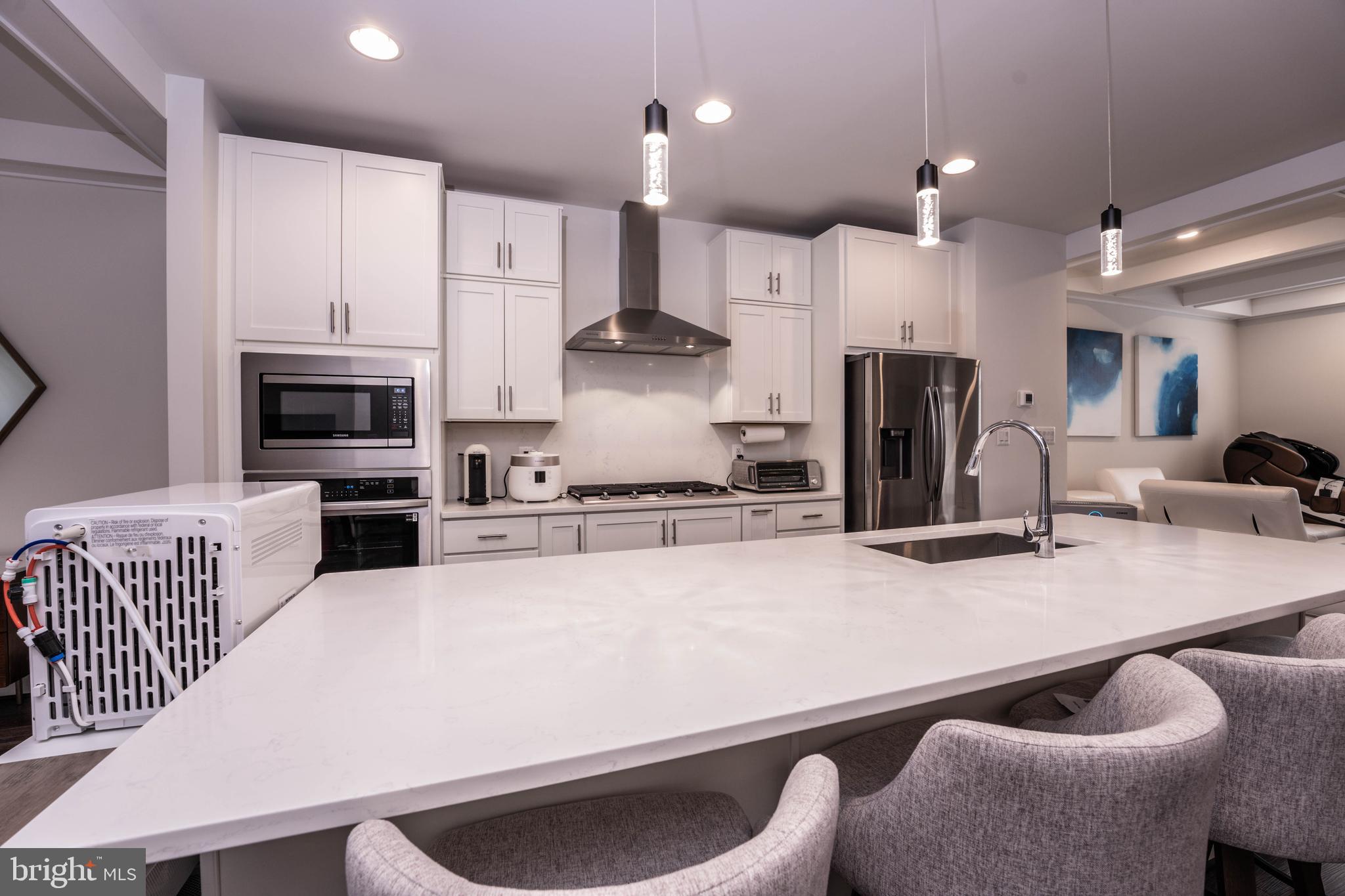 5207 Ridgeview Retreat Drive Chantilly, VA 20151 - Photo 4 of 28 a kitchen with stainless steel appliances kitchen island granite countertop a refrigerator a stove a sink a oven with white cabinets and chairs