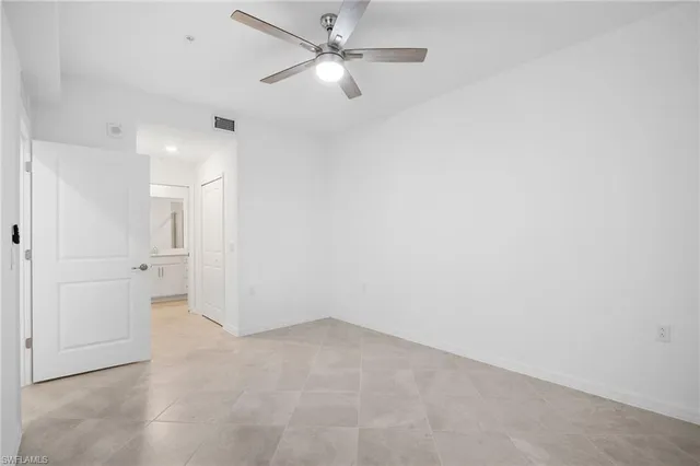 an empty room with a ceiling fan and a ceiling fan