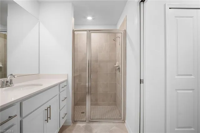 a bathroom with a shower sink and mirror