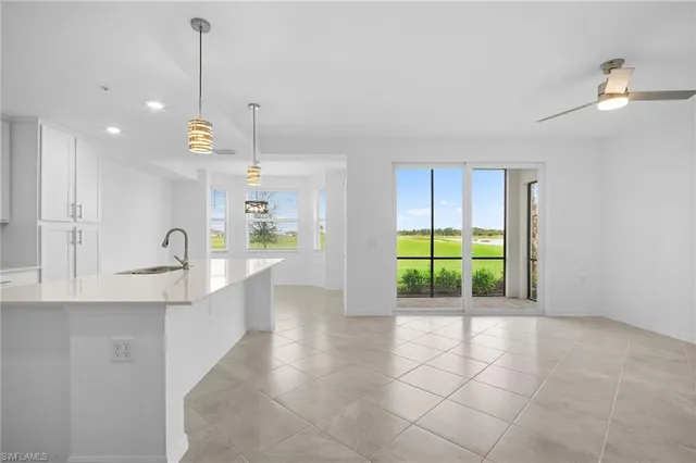 a view of a kitchen with a sink and windows