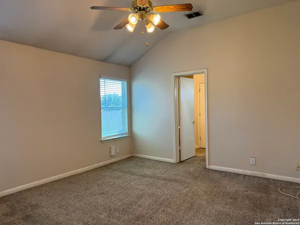 an empty room with closet and a bathroom
