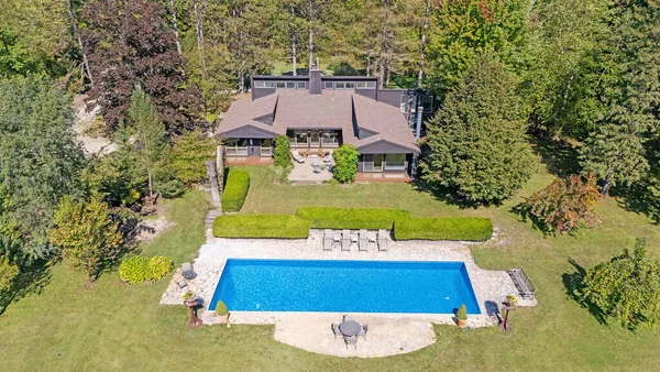 an aerial view of a house with yard swimming pool and outdoor seating