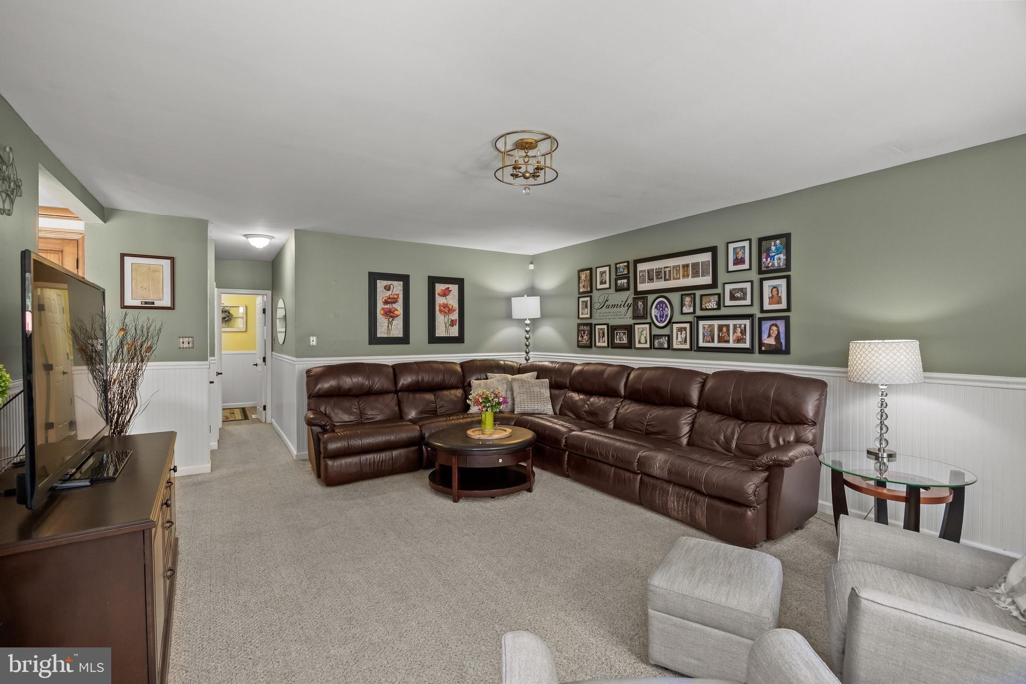 4 Sequoia Drive Cinnaminson, NJ 08077 - Photo 12 of 37 a living room with furniture a window and a flat screen tv