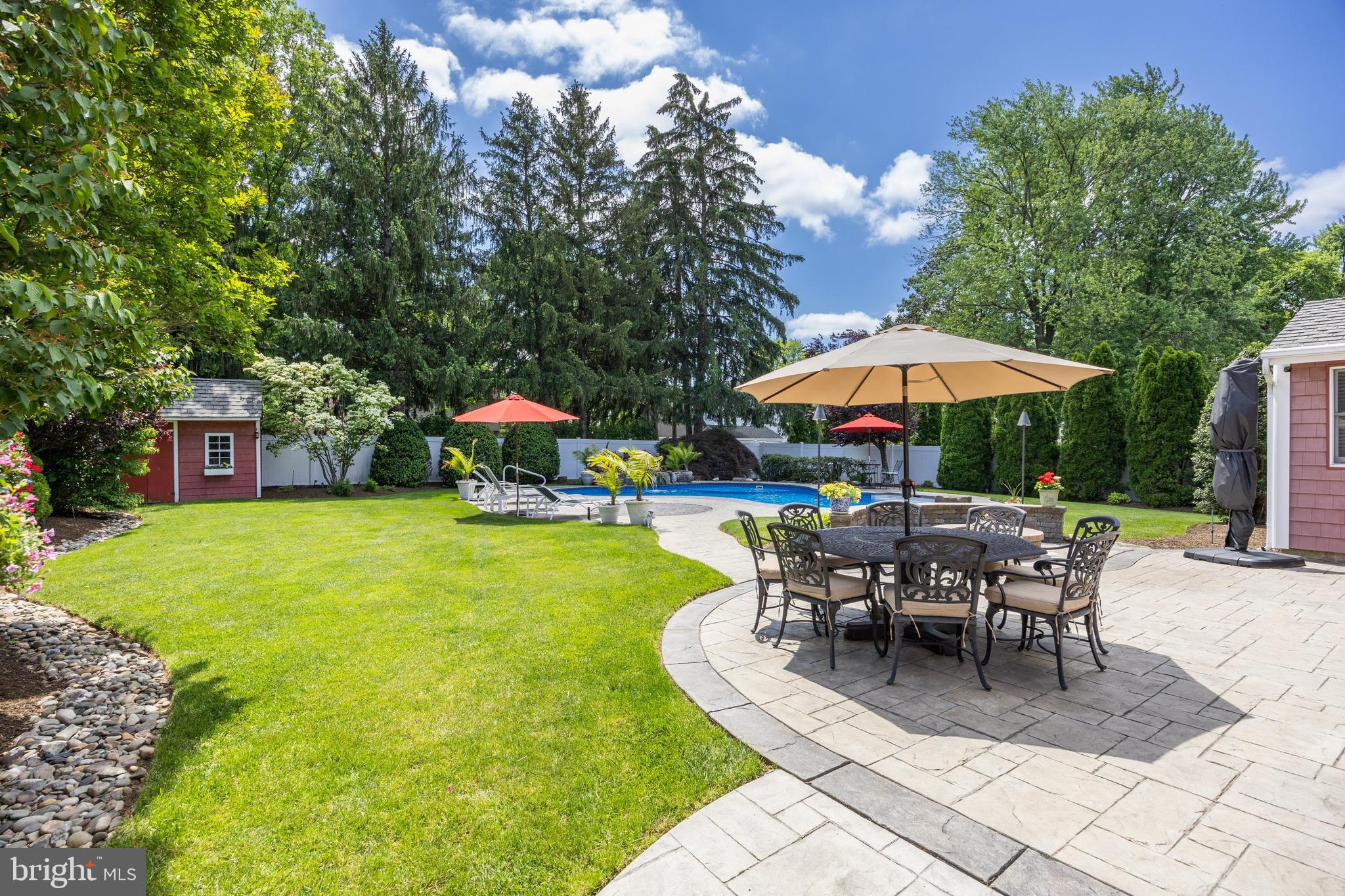 4 Sequoia Drive Cinnaminson, NJ 08077 - Photo 31 of 37 a view of a swimming pool with table and chairs under an umbrella