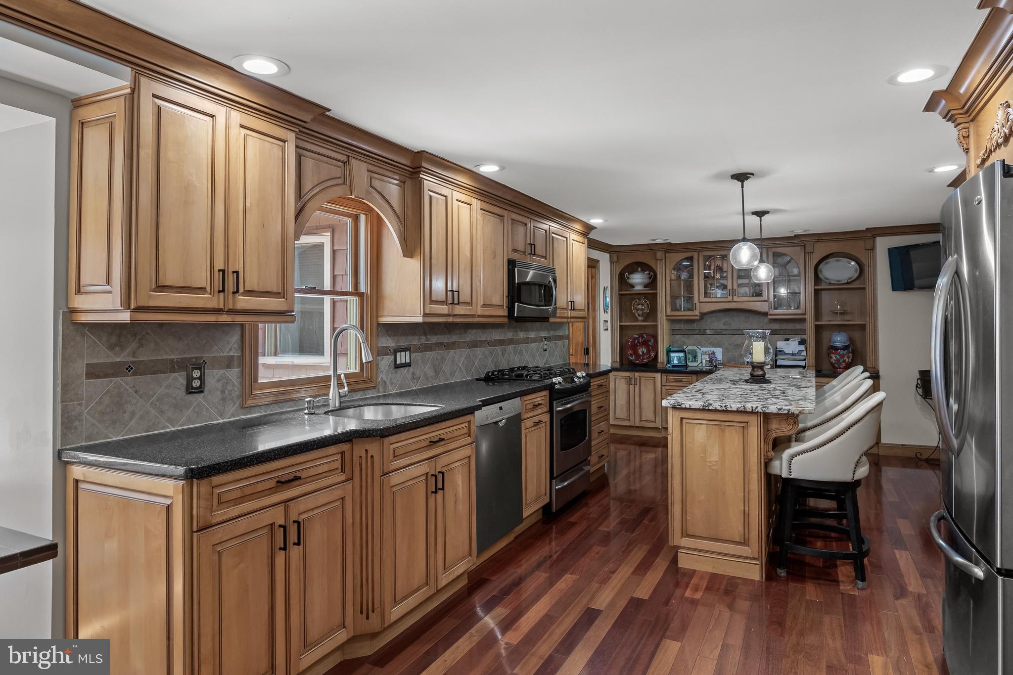 4 Sequoia Drive Cinnaminson, NJ 08077 - Photo 6 of 37 a kitchen with stainless steel appliances granite countertop a sink stove cabinets and wooden floor