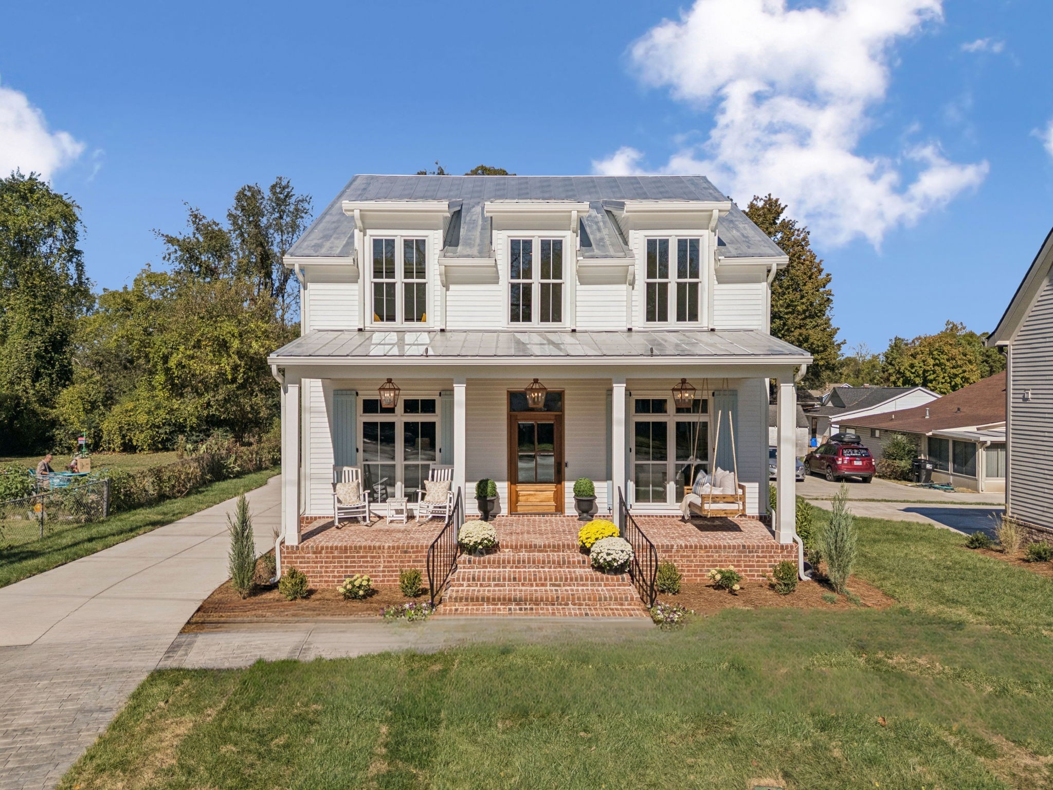 a front view of a house with garden and sitting area
