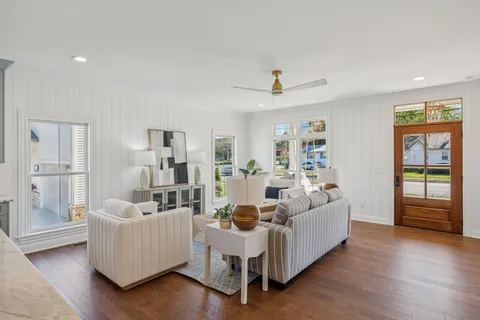 a living room with furniture and wooden floor