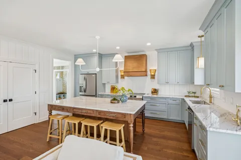 a kitchen that has a table and chairs in it