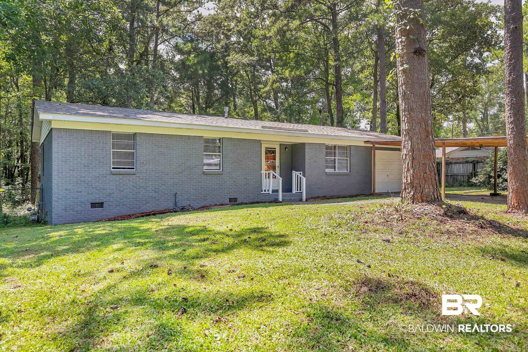 3304 Armond Drive Mobile, AL 36605 - Photo 60 of 62 Ranch-style house with crawl space, brick siding, an attached garage, and view of wooded area