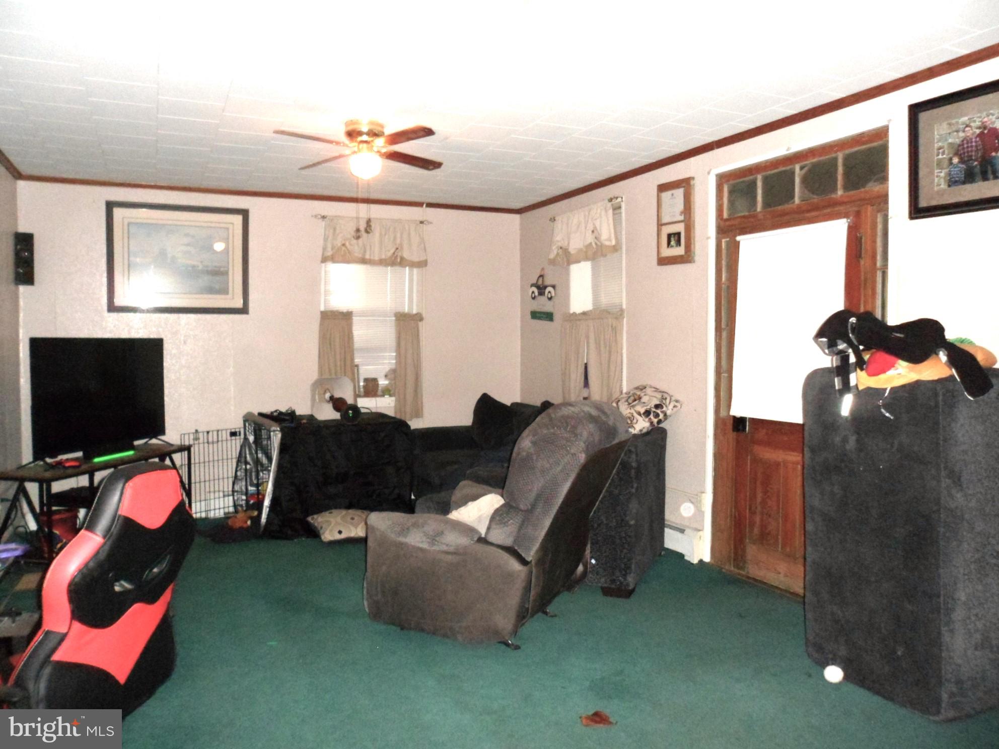 7548 Linglestown Road Harrisburg, PA 17112 - Photo 13 of 38 a living room with furniture a flat screen tv and a window