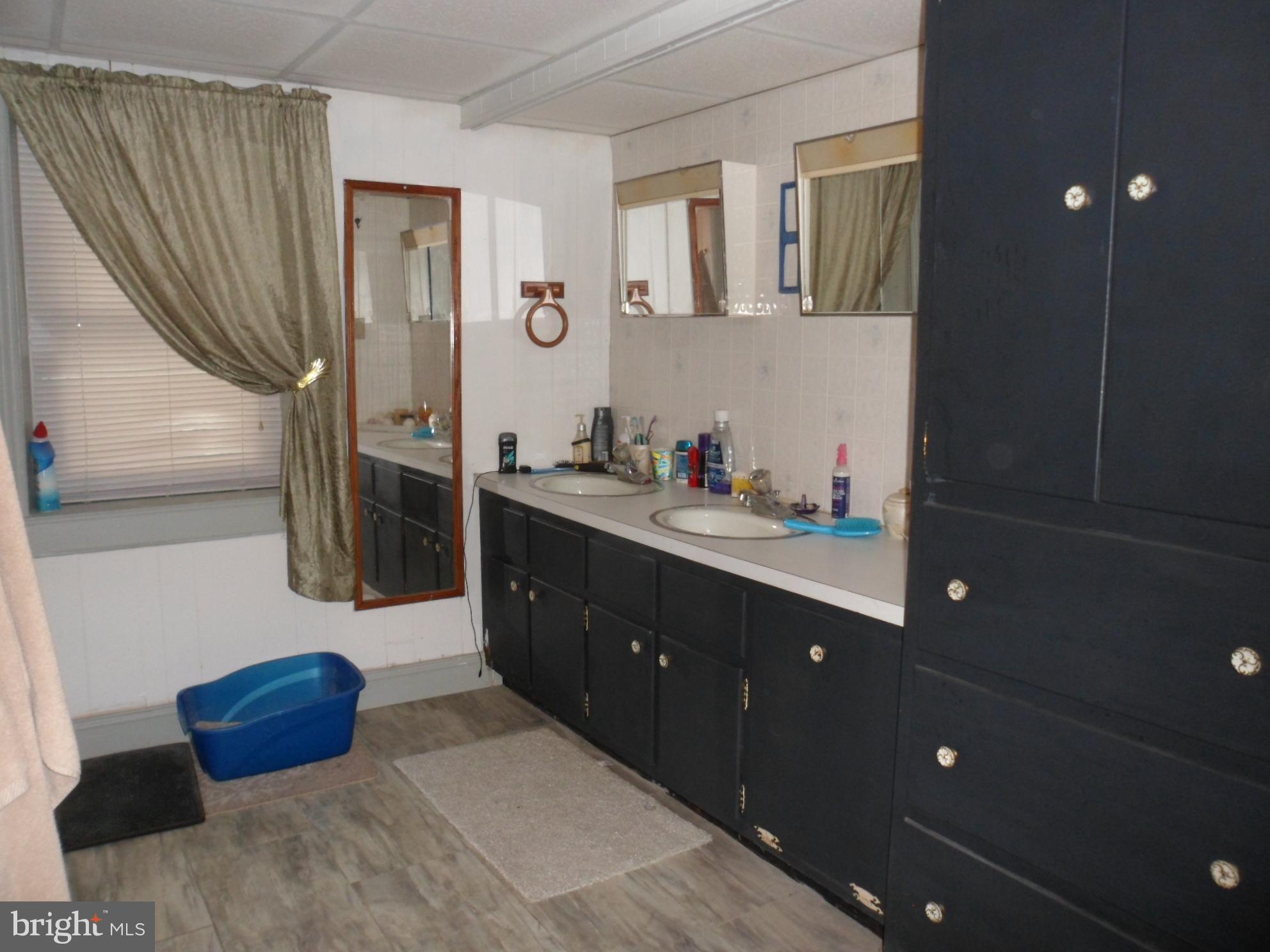 7548 Linglestown Road Harrisburg, PA 17112 - Photo 15 of 38 a spacious bathroom with a double vanity sink a large mirror and a shower
