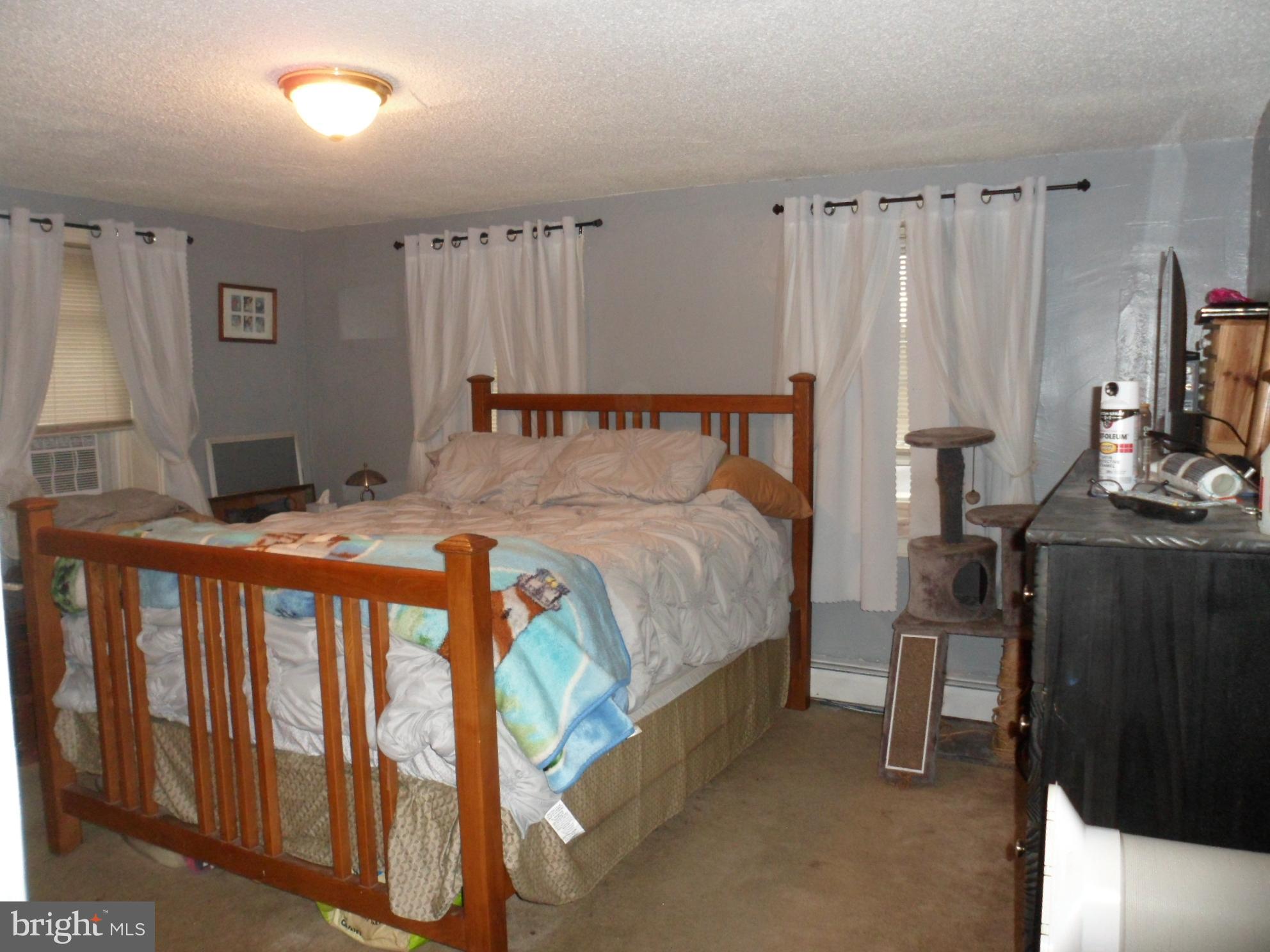 7548 Linglestown Road Harrisburg, PA 17112 - Photo 16 of 38 a bedroom with a bed and a flat tv screen on dresser
