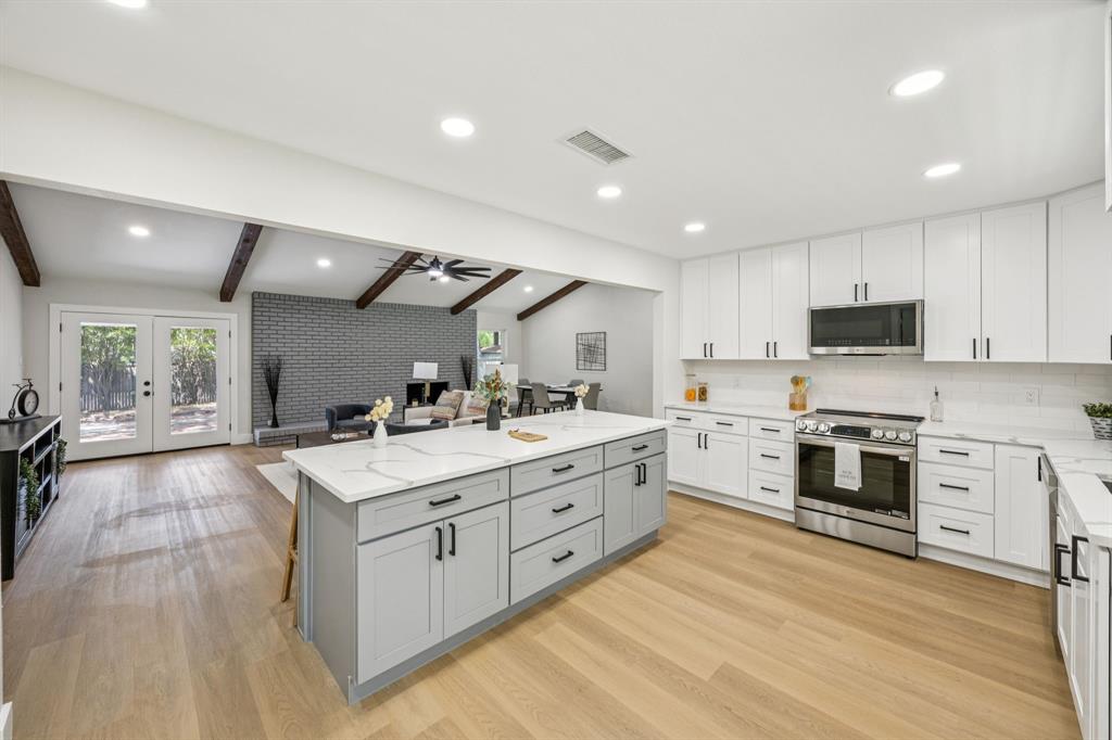 37 Devonshire Bedford, TX 76021 - Photo 14 of 39 a large white kitchen with stainless steel appliances granite countertop a stove and a sink