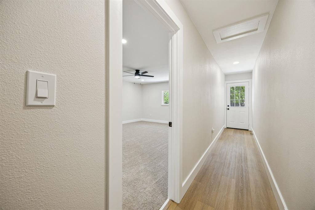 37 Devonshire Bedford, TX 76021 - Photo 19 of 39 a view of a hallway with wooden floor and a bathroom