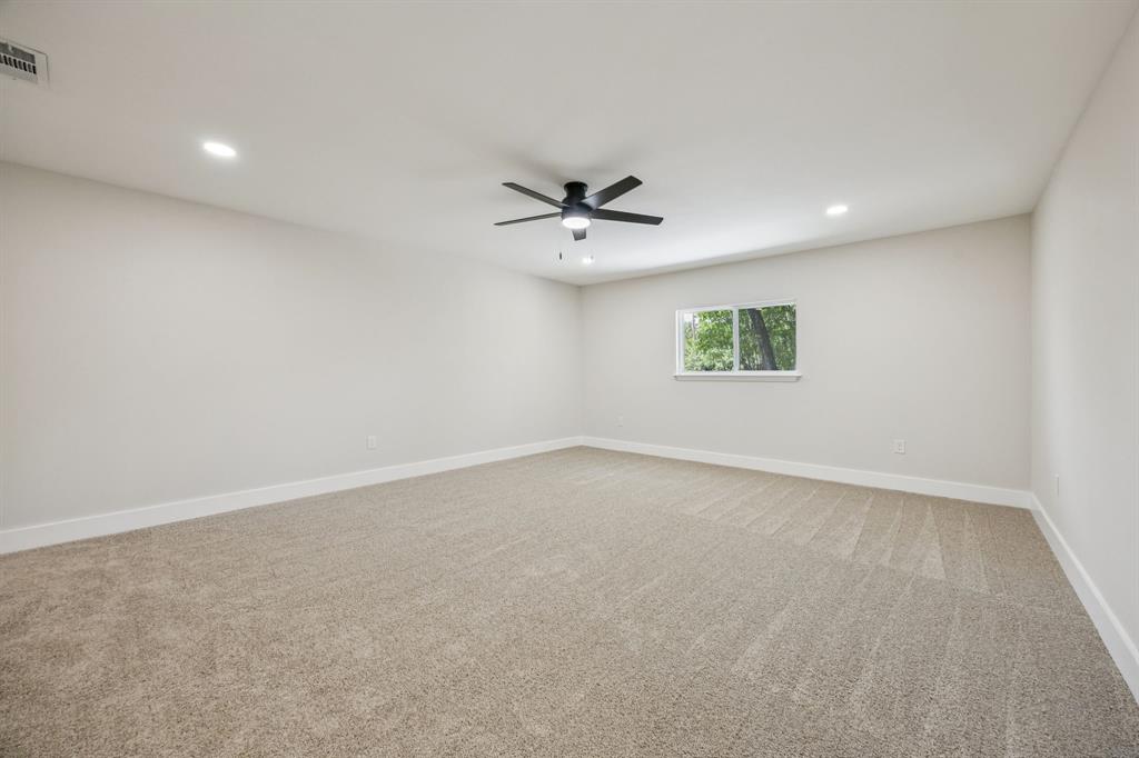 37 Devonshire Bedford, TX 76021 - Photo 20 of 39 an empty room with a window and a ceiling fan