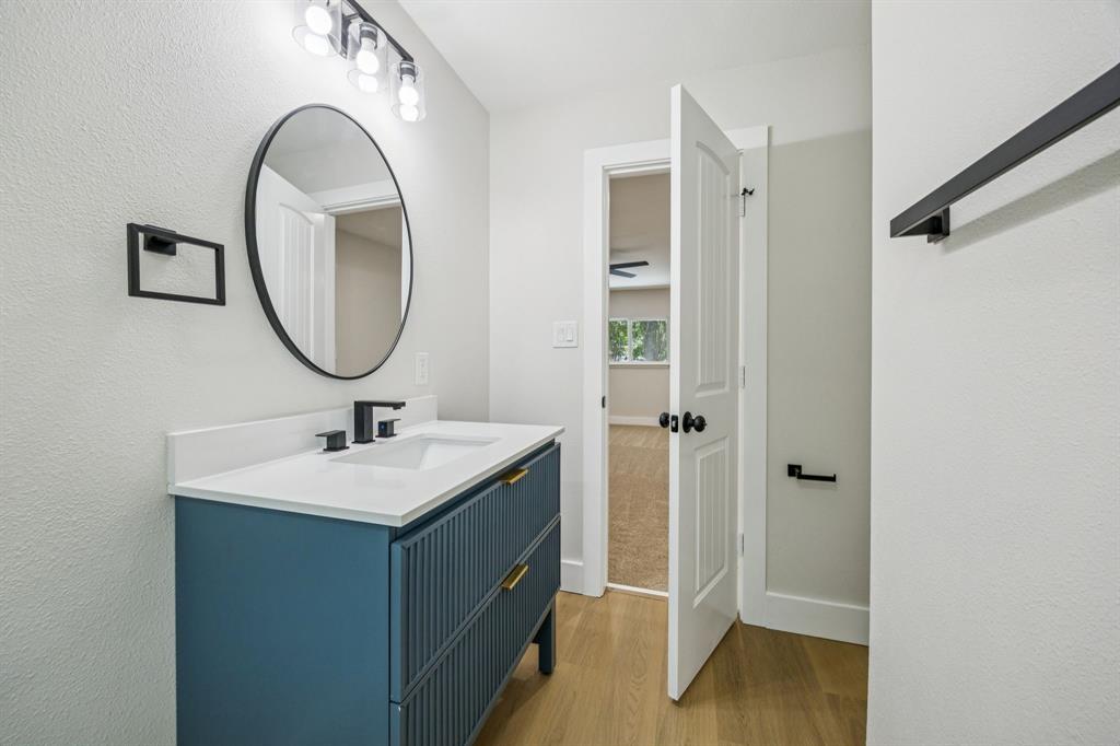 37 Devonshire Bedford, TX 76021 - Photo 25 of 39 a bathroom with a sink a mirror and vanity