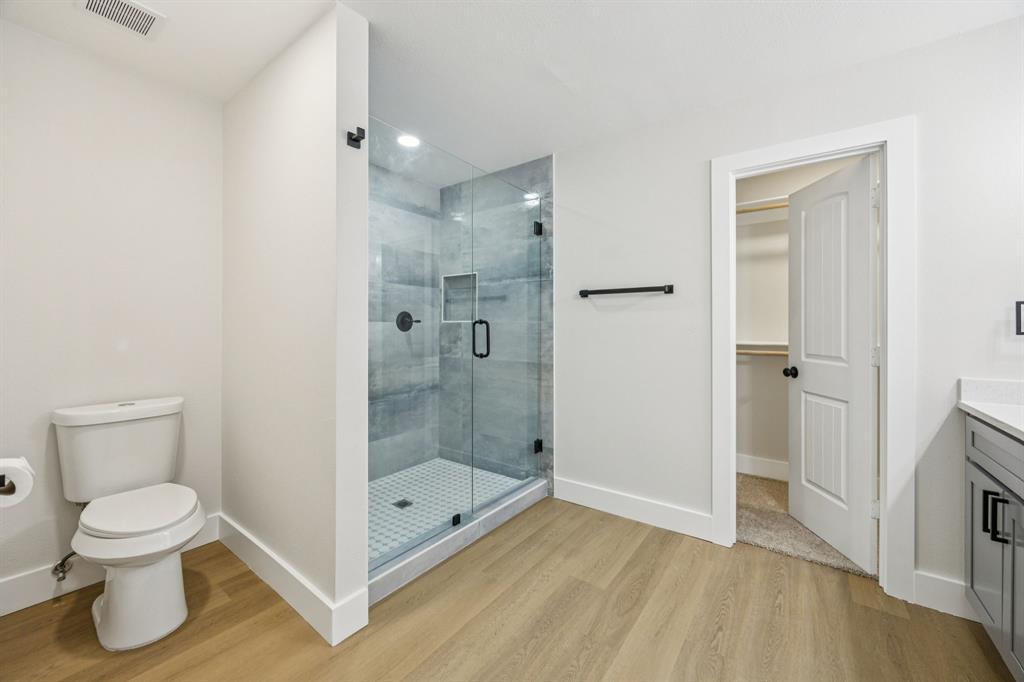 37 Devonshire Bedford, TX 76021 - Photo 32 of 39 a bathroom with a toilet and a shower