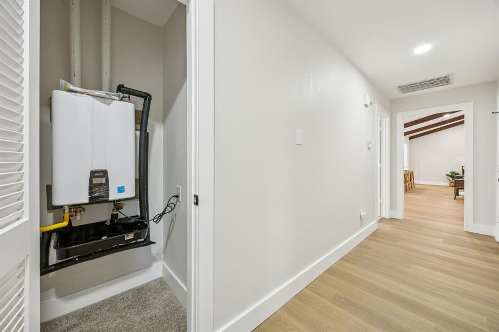 37 Devonshire Bedford, TX 76021 - Photo 36 of 39 a view of a hallway with bathroom and wooden floor