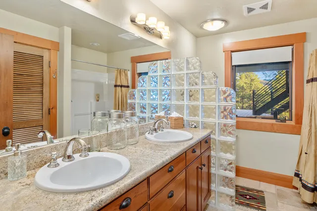 a bathroom with a granite countertop sink and a mirror