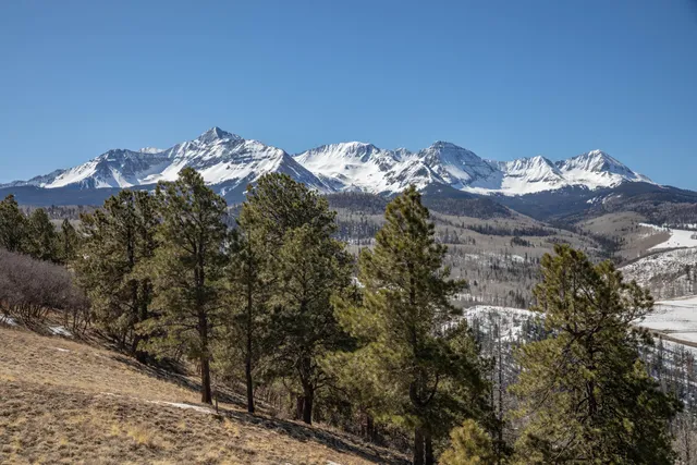 a view of a house with a yard and mountain view