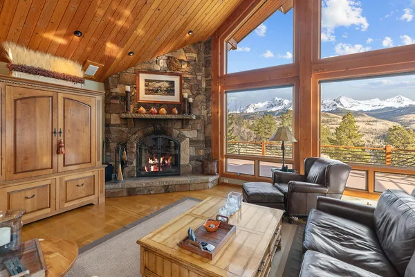 a living room with furniture large window and fireplace