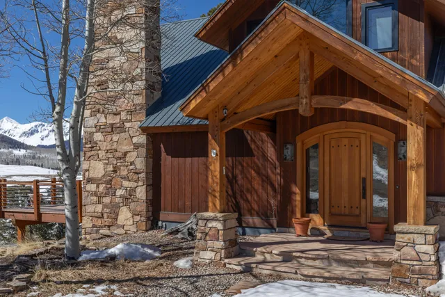 a view of a porch with a table and chairs