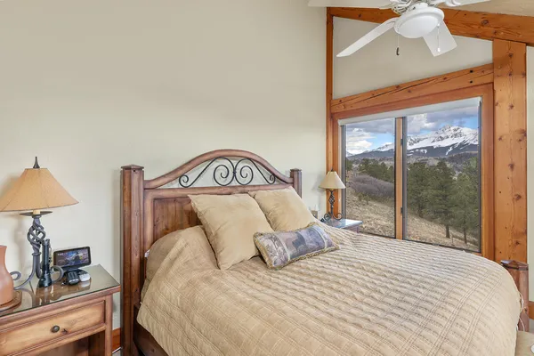 a bedroom with a large bed and a window