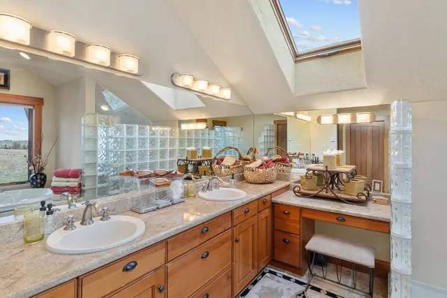 a room with stainless steel appliances kitchen island granite countertop a sink and cabinets