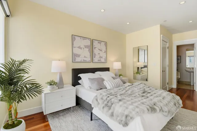 a bedroom with a bed and a window with painted walls