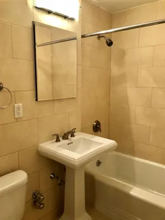 a bathroom with a sink and mirror with toilet