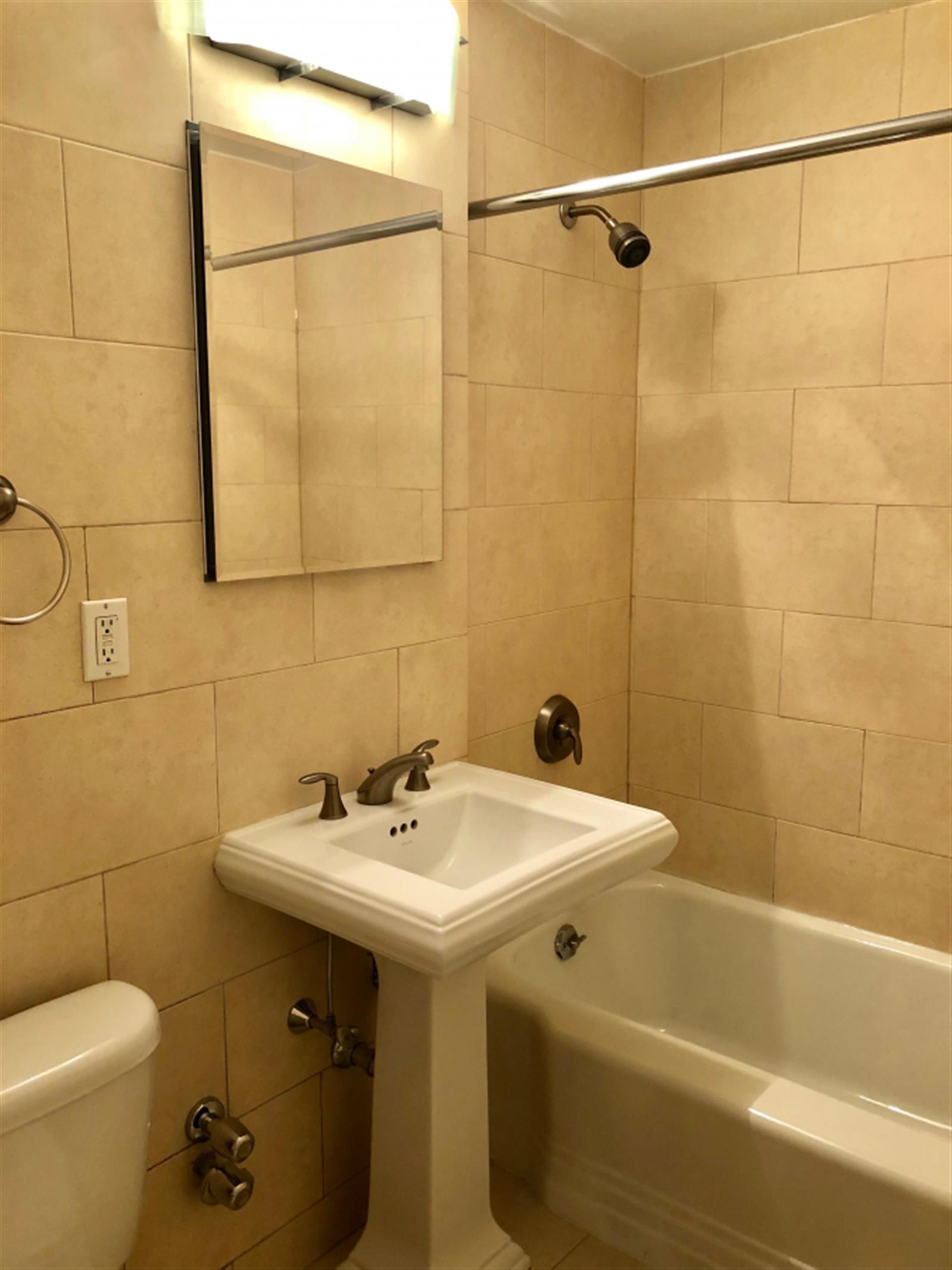 41 Park Avenue, Unit 7B Manhattan, NY 10016 - Photo 8 of 9 a bathroom with a sink and mirror with toilet