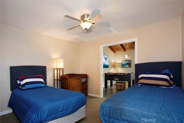 a bedroom with bed and wooden floor