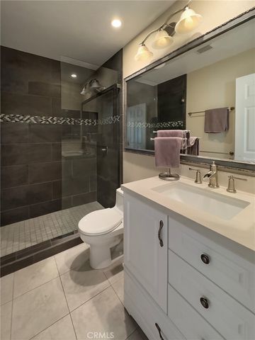 a bathroom with a sink toilet a mirror and shower