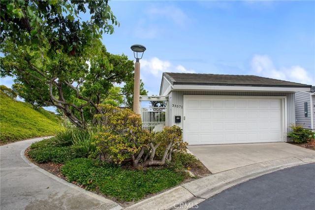 a front view of a house with a yard garage and garage