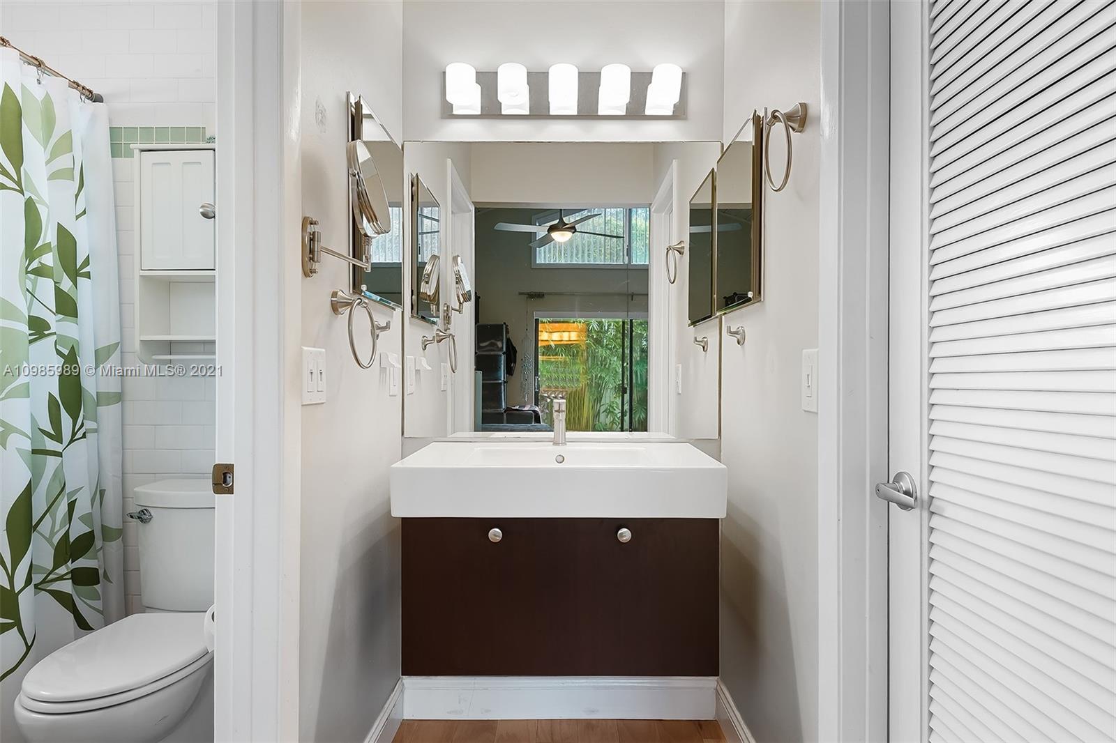 21518 Kapok Circle Boca Raton, FL 33433 - Photo 14 of 30 a bathroom with a sink and a mirror with toilet