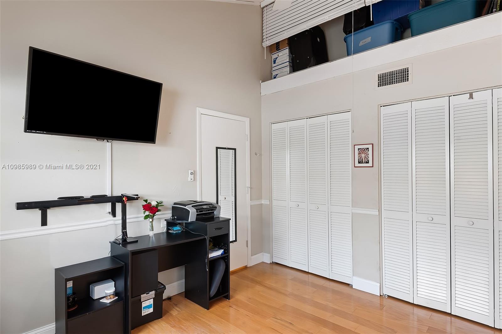 21518 Kapok Circle Boca Raton, FL 33433 - Photo 18 of 30 a view of a workspace with a flat screen tv