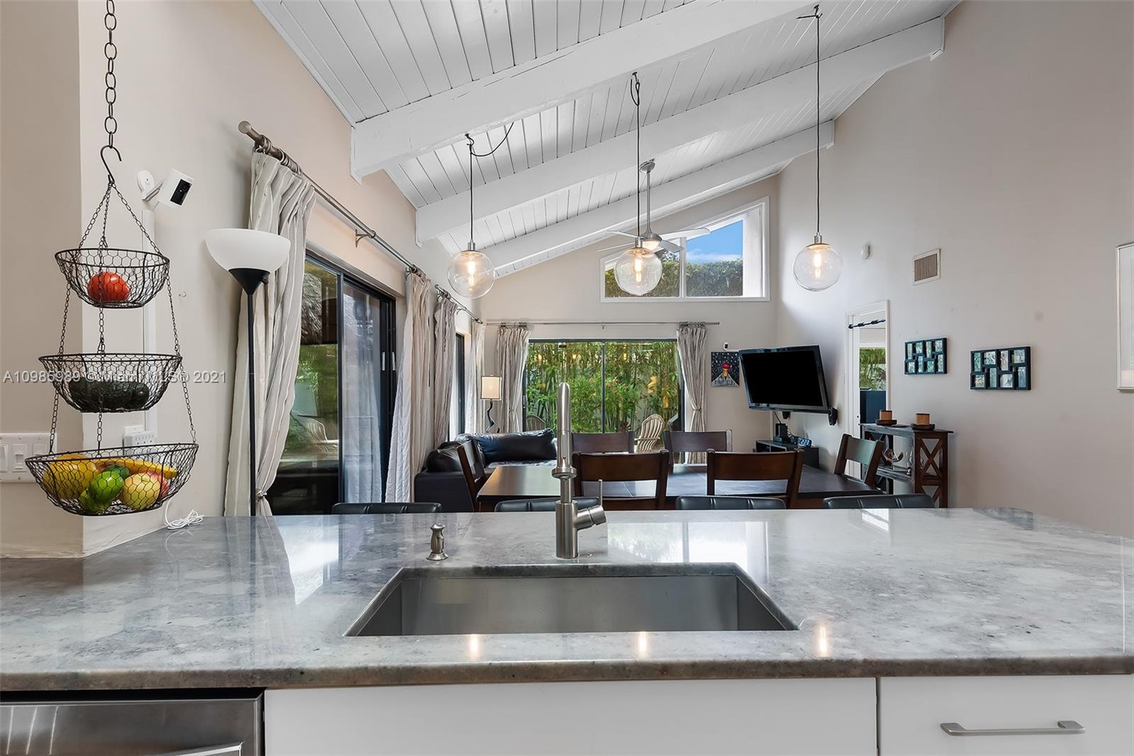21518 Kapok Circle Boca Raton, FL 33433 - Photo 22 of 30 a kitchen with kitchen island granite countertop a sink a counter top space and living room view