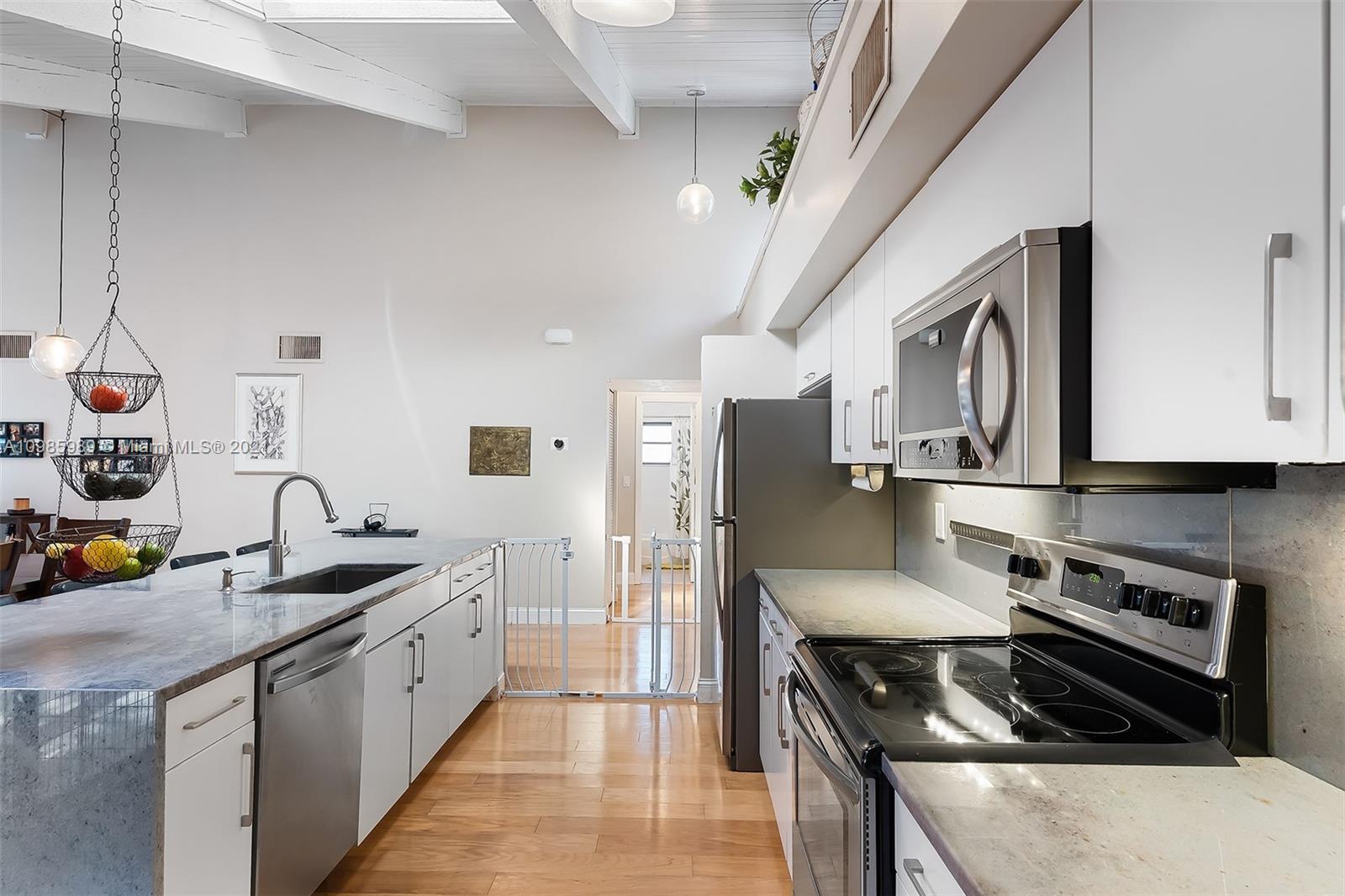 21518 Kapok Circle Boca Raton, FL 33433 - Photo 24 of 30 a kitchen with stainless steel appliances granite countertop a sink stove and refrigerator
