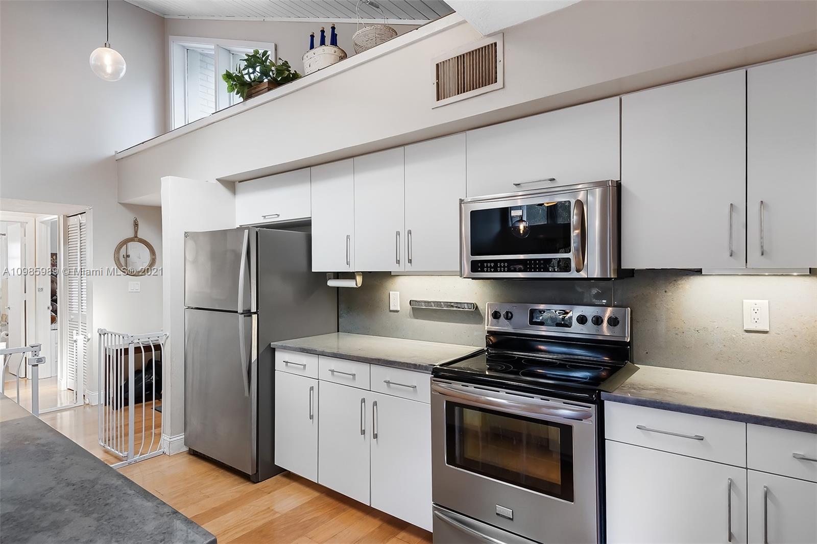 21518 Kapok Circle Boca Raton, FL 33433 - Photo 25 of 30 a kitchen with stainless steel appliances a stove microwave and refrigerator