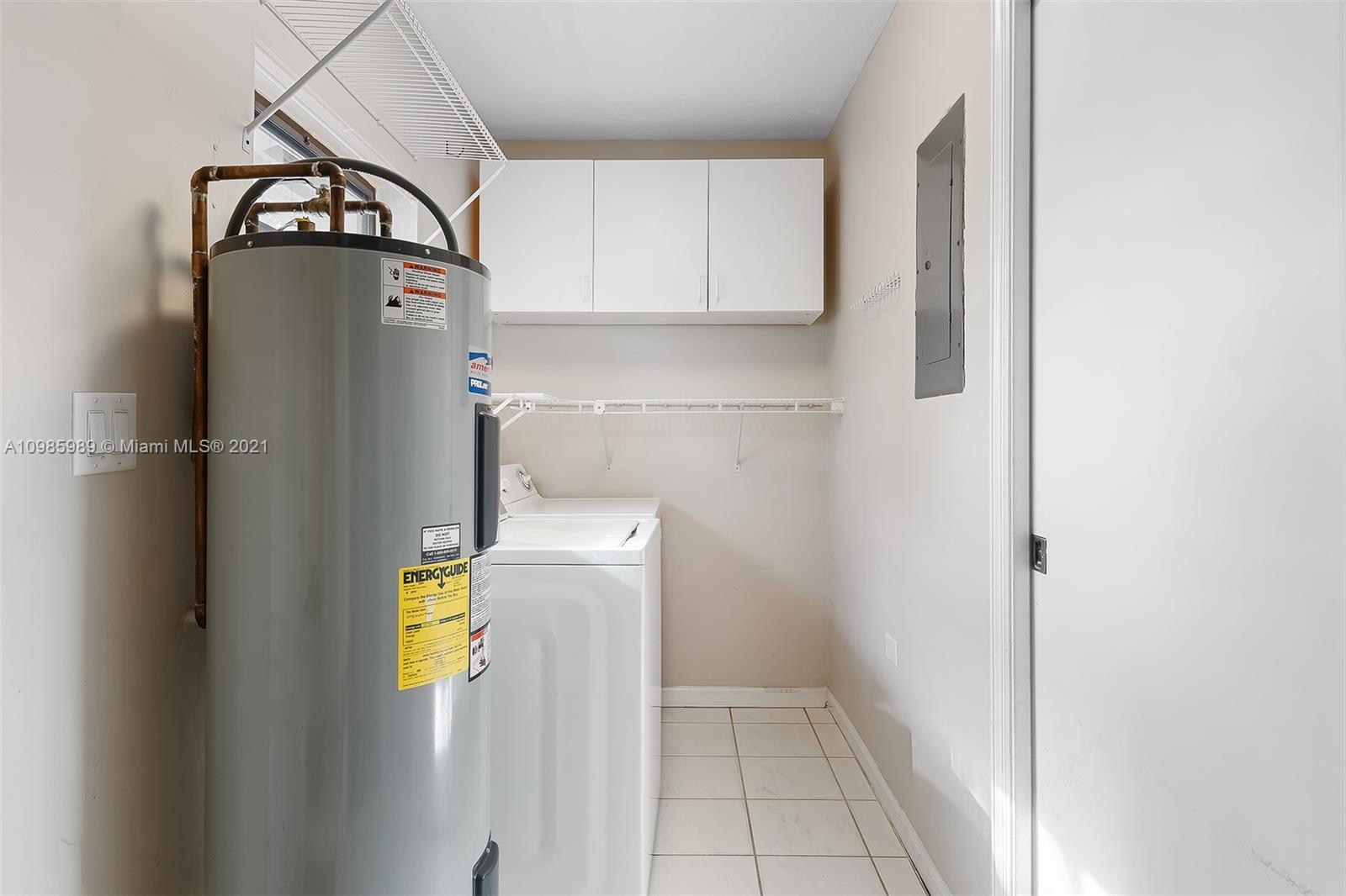 21518 Kapok Circle Boca Raton, FL 33433 - Photo 26 of 30 a view of a storage & utility room with a refrigerator