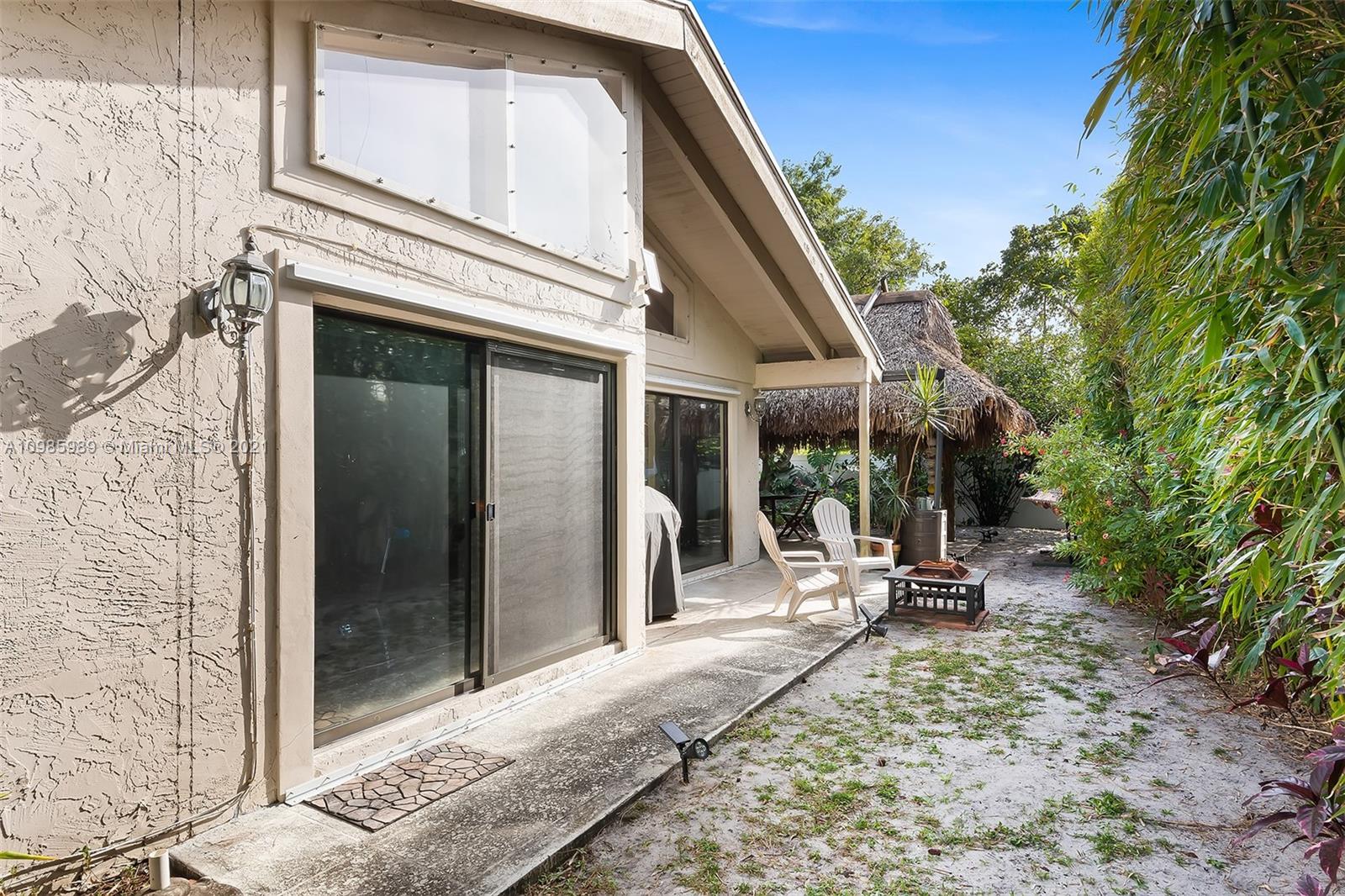 21518 Kapok Circle Boca Raton, FL 33433 - Photo 30 of 30 a view of a patio with a table and chairs and floor to ceiling window