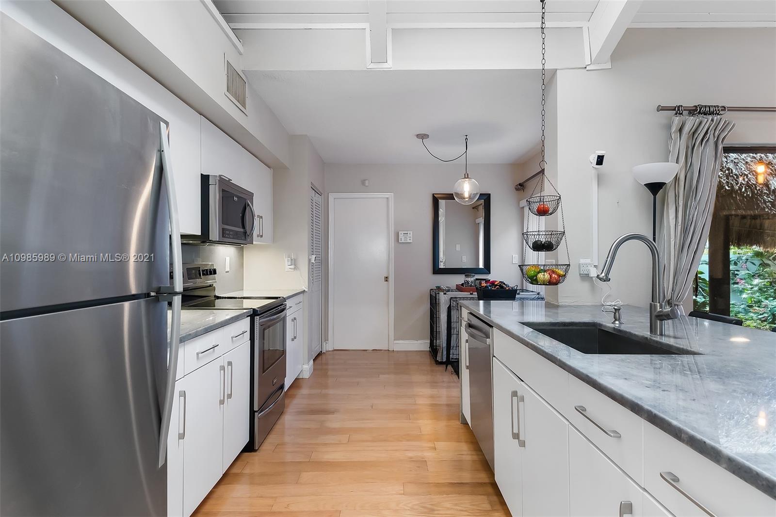 21518 Kapok Circle Boca Raton, FL 33433 - Photo 3 of 30 a kitchen with granite countertop a sink stainless steel appliances a counter top space and cabinets