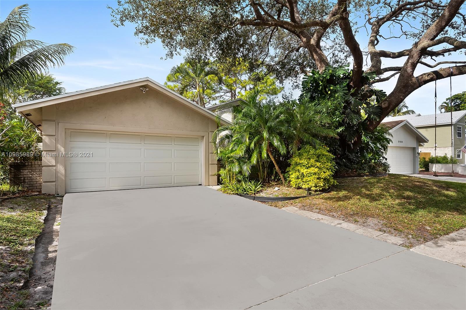 21518 Kapok Circle Boca Raton, FL 33433 - Photo 10 of 30 a small yard with a large tree in front of it