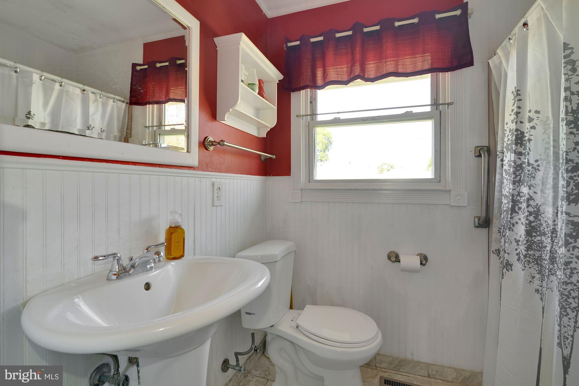 446 Flanders Road Bellmawr, NJ 08031 - Photo 15 of 29 a bathroom with a sink a toilet and mirror