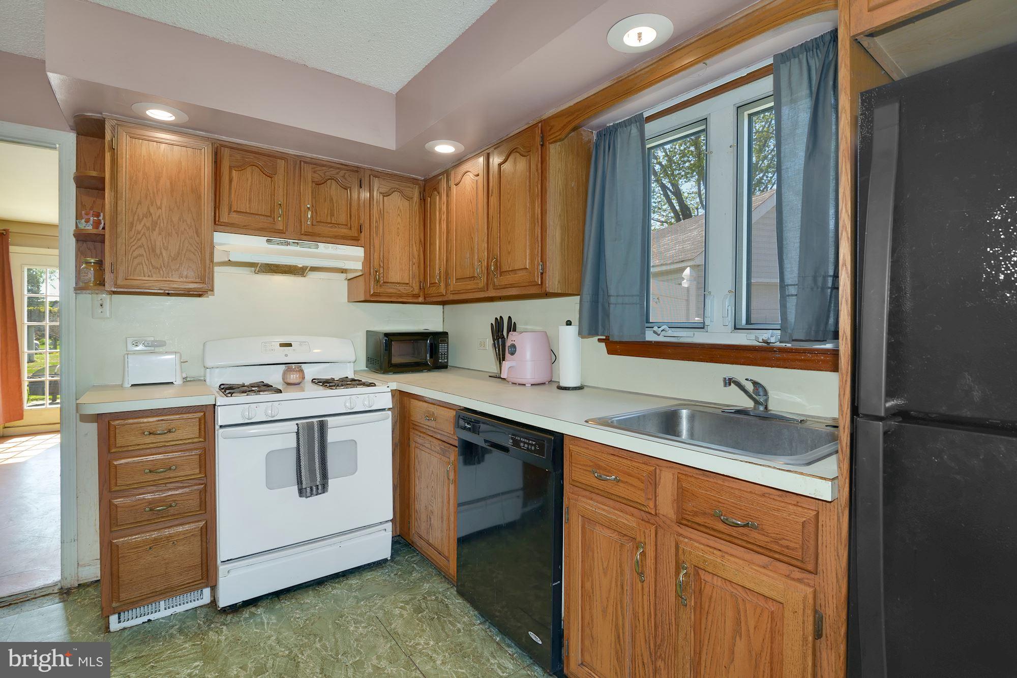 446 Flanders Road Bellmawr, NJ 08031 - Photo 7 of 29 a kitchen with a sink stove and cabinets