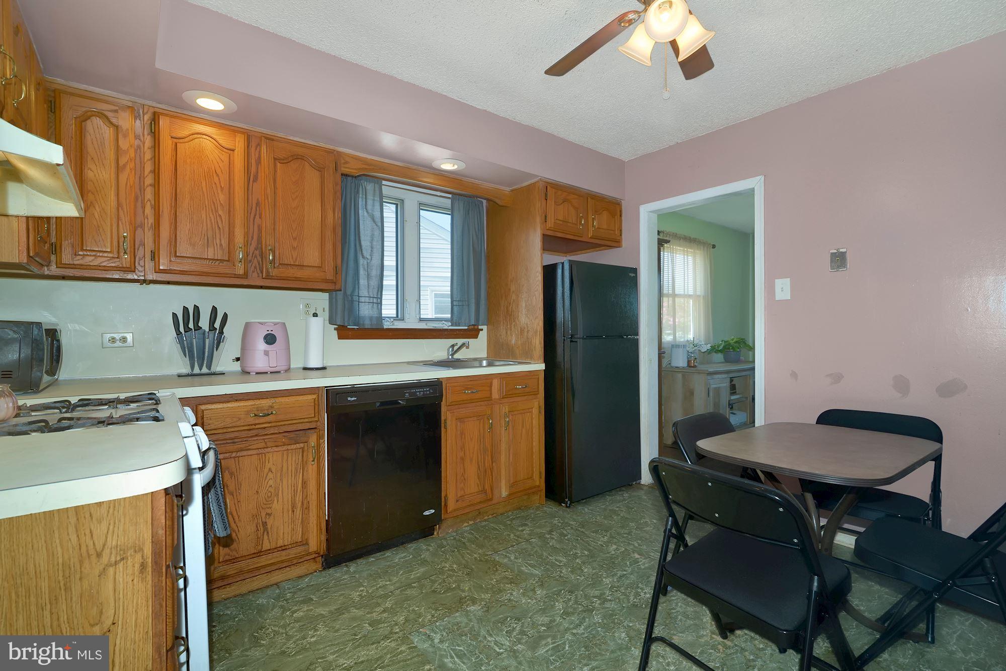 446 Flanders Road Bellmawr, NJ 08031 - Photo 8 of 29 a kitchen with a stove a refrigerator and a sink