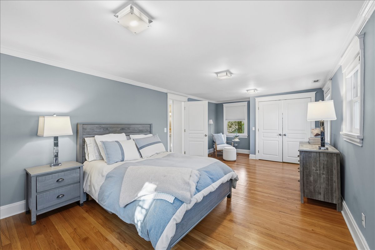1082 Ash Street Winnetka, IL 60093 - Photo 36 of 54 a large bedroom with a bed and wooden floor