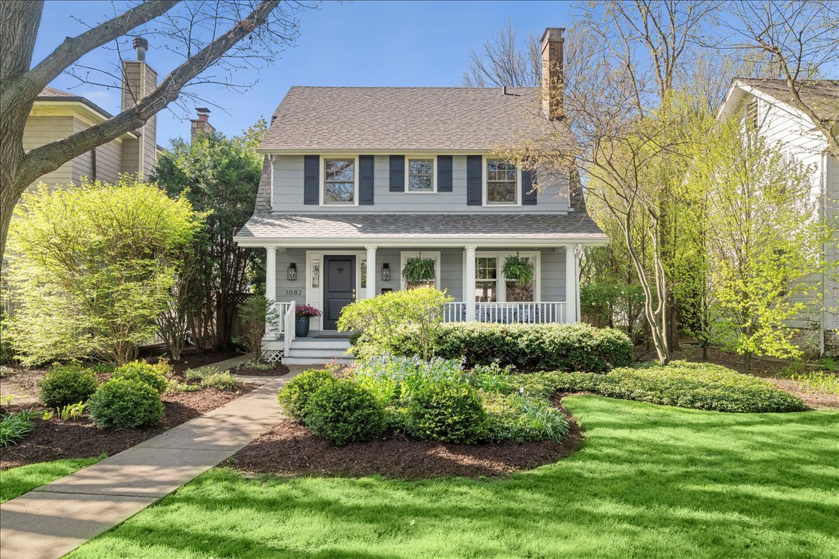 1082 Ash Street Winnetka, IL 60093 - Photo 4 of 54 a front view of a house with garden