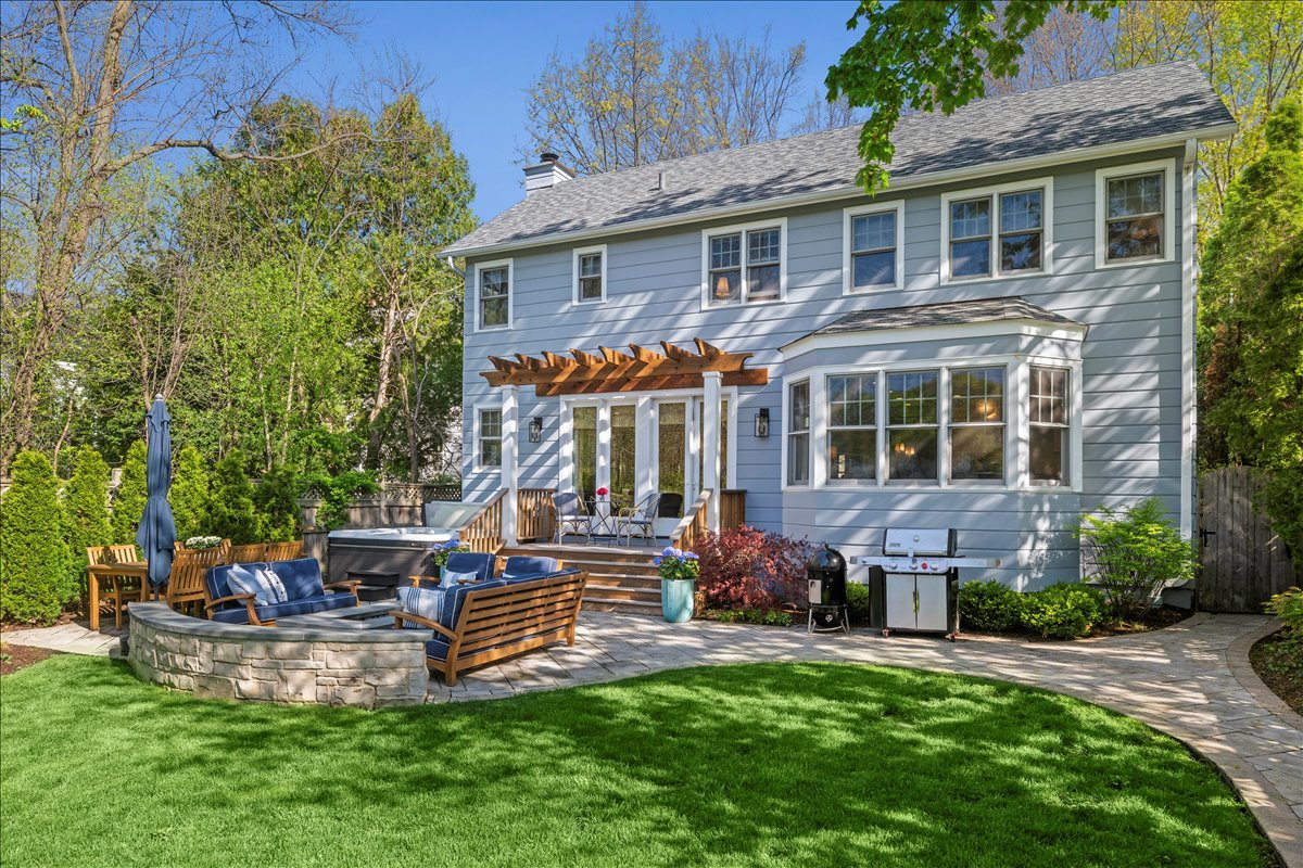 1082 Ash Street Winnetka, IL 60093 - Photo 48 of 54 a front view of a house with a yard table and chairs