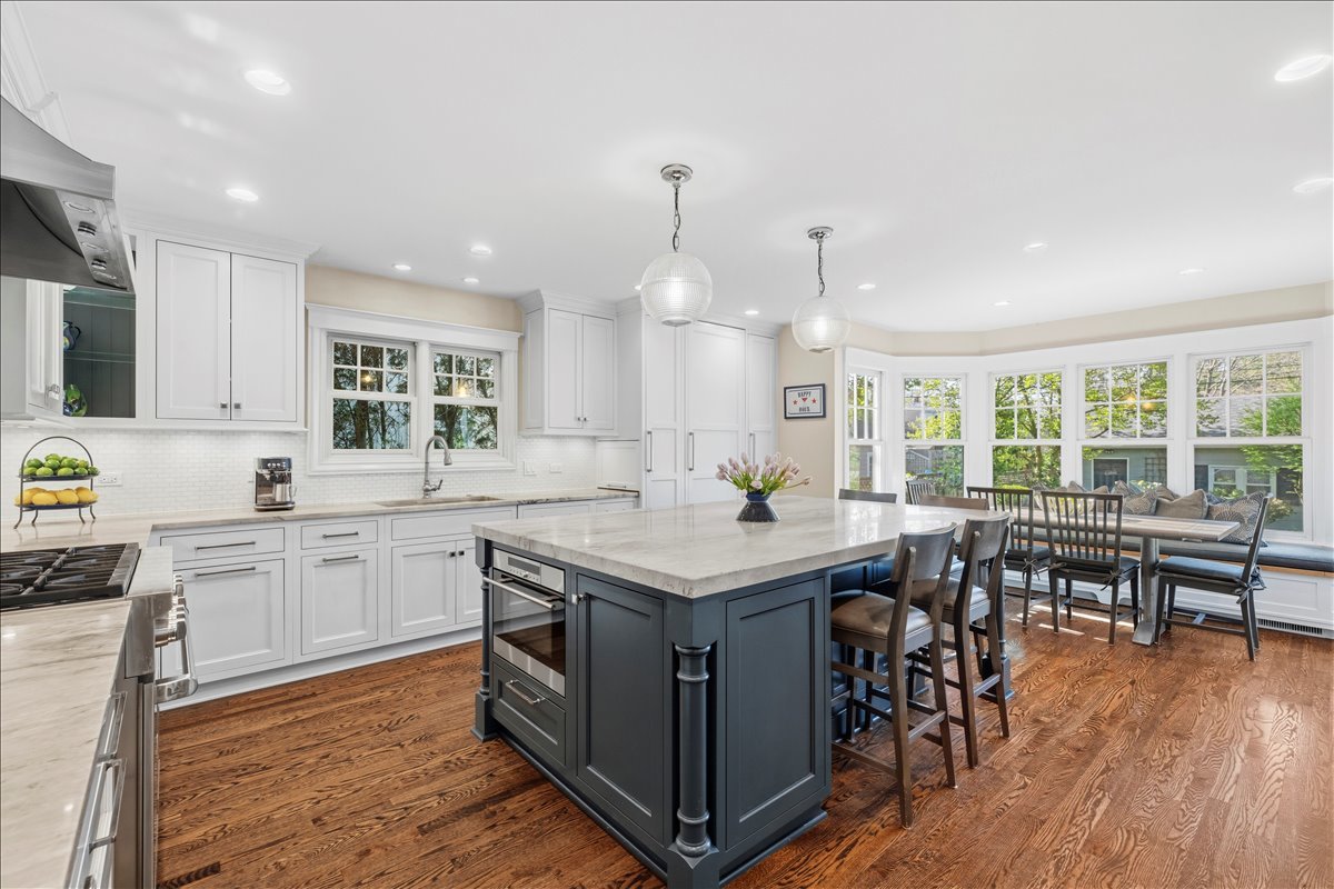1082 Ash Street Winnetka, IL 60093 - Photo 8 of 54 a kitchen with a table chairs stove and wooden floor